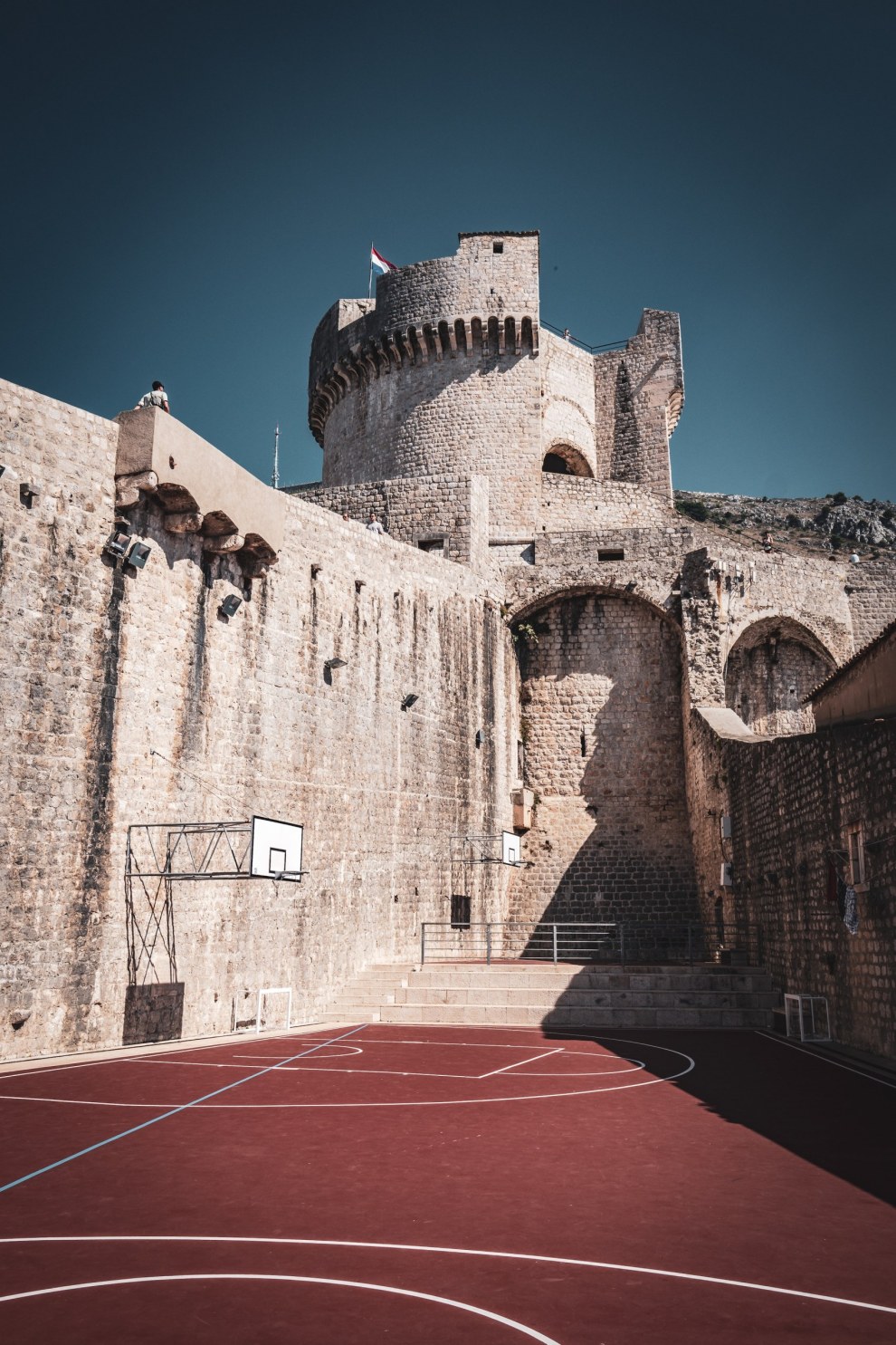 Basketball court at the foot of the massive old fortress walls of Dubrovnik, Croatia