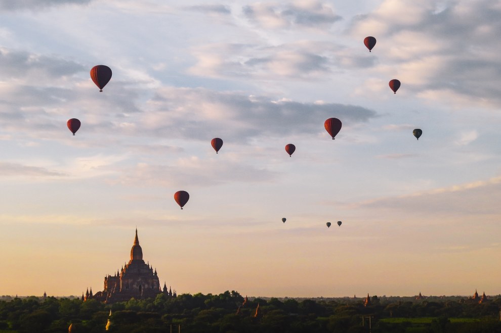 Hot-air balloons drifting over the temple plain of Bagan, Myanmar, at sunrise