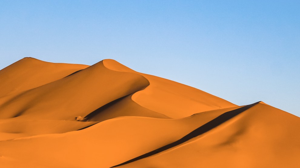 Orange sand dunes of Erg Chebbi near Merzouga, Morocco, under a clear blue sky
