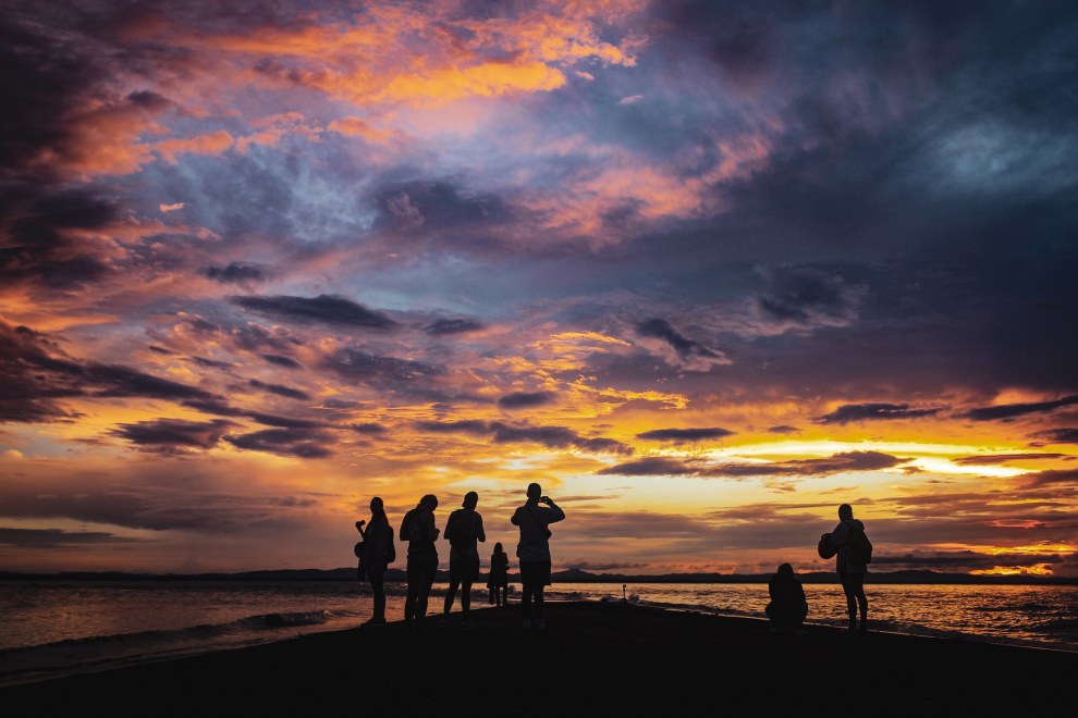 Silhouettes of people watching a dramatic sunset sky at Punta Jesús María on Ometepe Island, Nicaragua