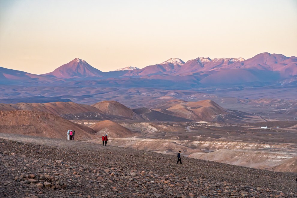 Two hikers on a rocky trail in the Valle de la Luna, Chile
