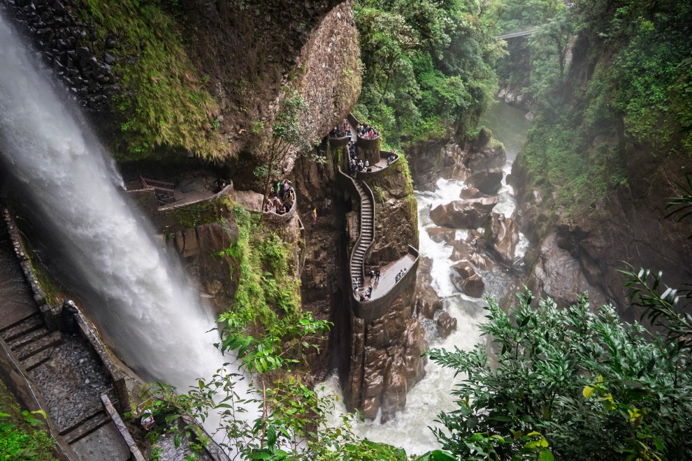 Waterfall plunging into a gorge beside a spiral staircase built into the rock, El Pailón del Diablo, Ecuador