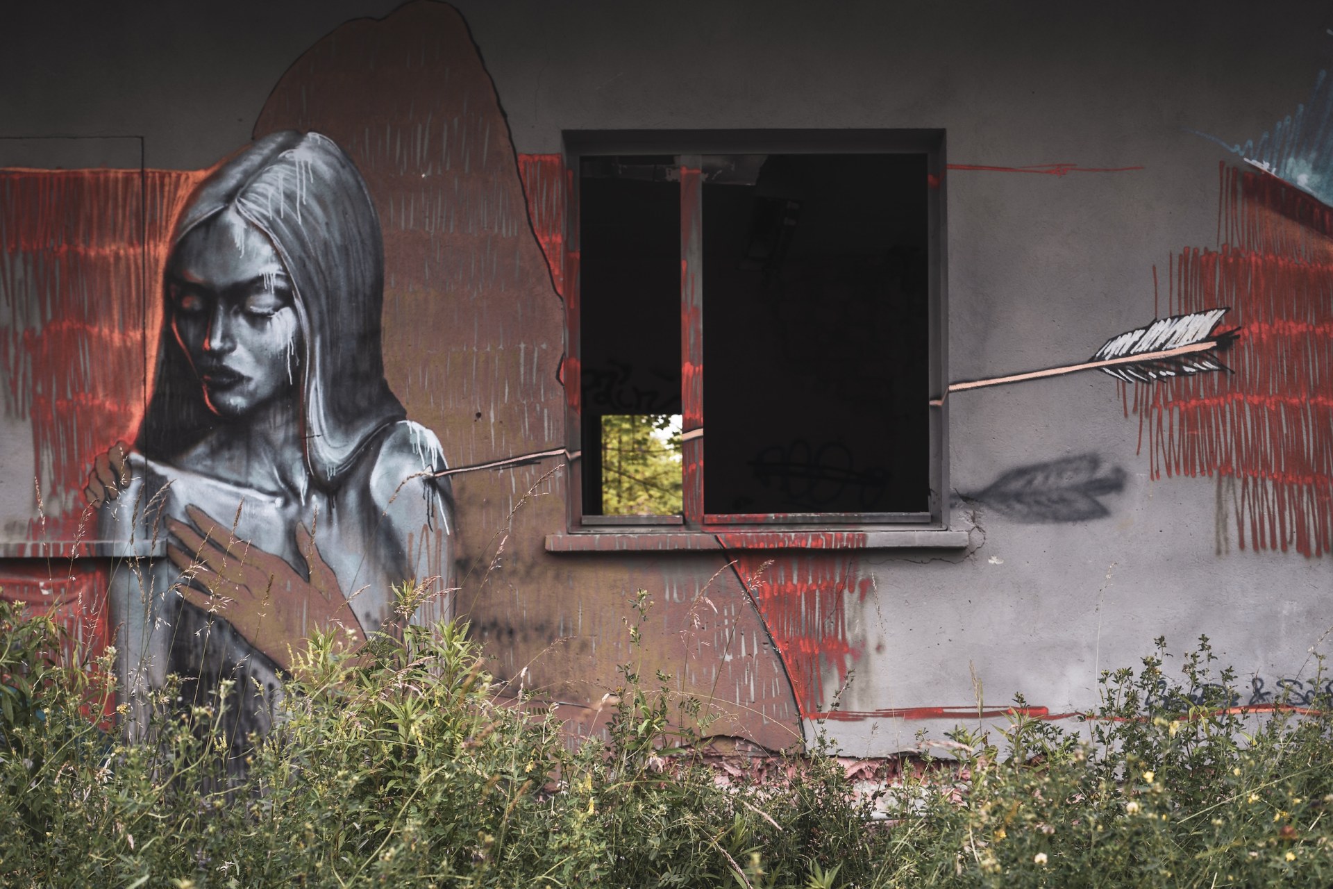 Large mural of a woman beside an empty window on a derelict wall, Rüdersdorf, Germany