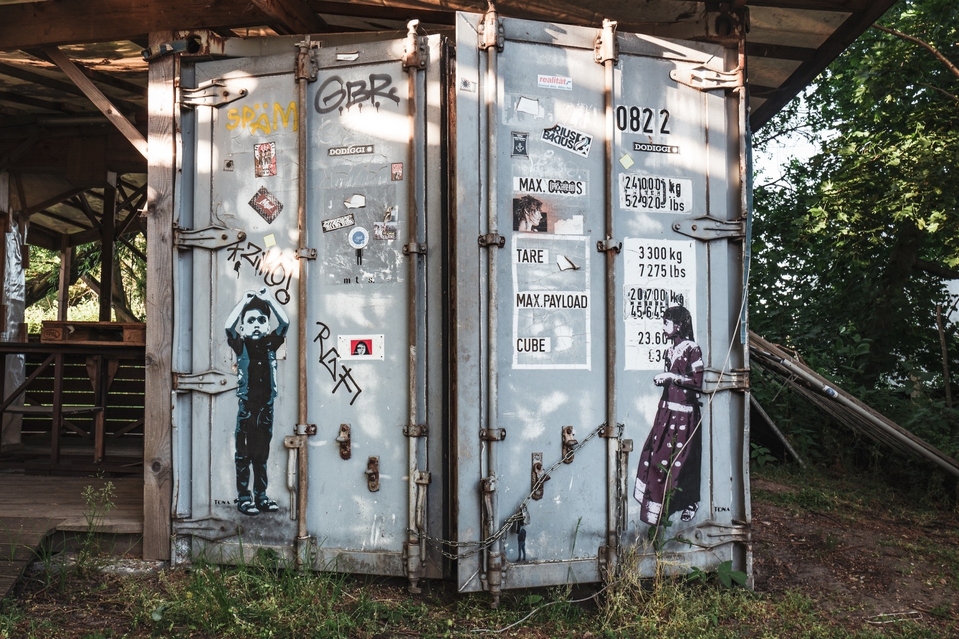 Shipping container doors covered in stickers and stencil art at the deserted MS Dockville festival site, Hamburg-Wilhelmsburg, Germany, summer 2020